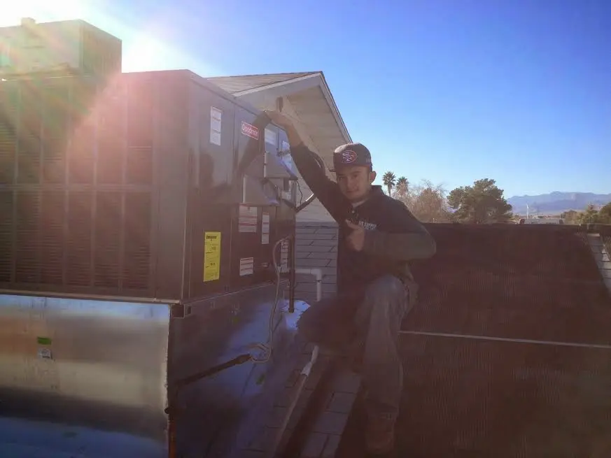 HVAC technician performing HVAC Inspection on a rooftop unit in Readington